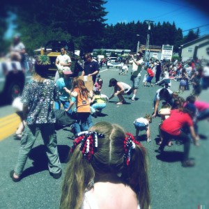 We all know the mad scramble for small reward. ("Pigtails and Parade Candy Scramble" by Meegan Reid)